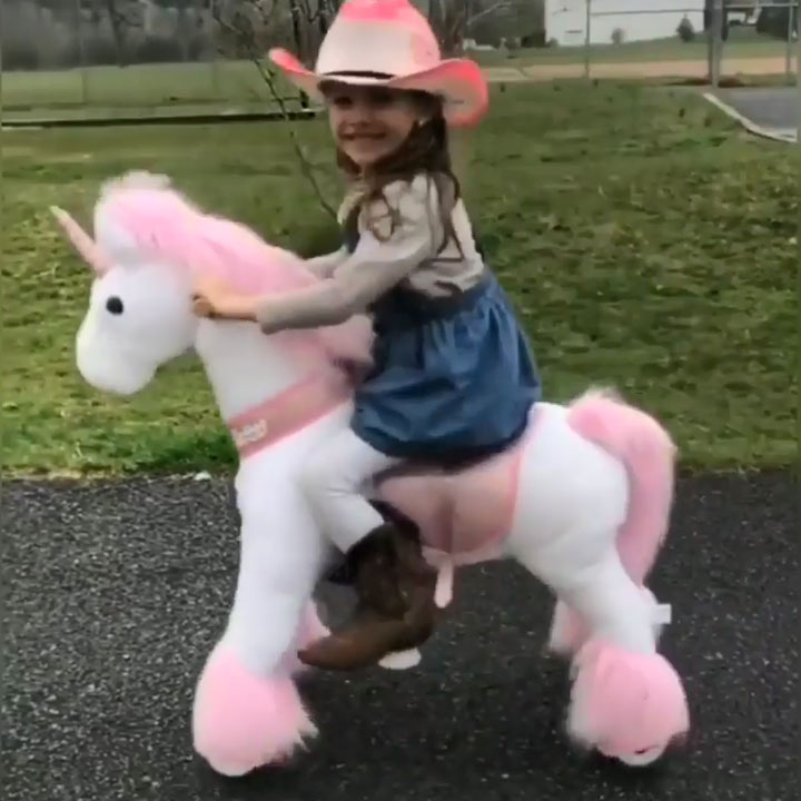 Cow girl with her walking unicorn toy